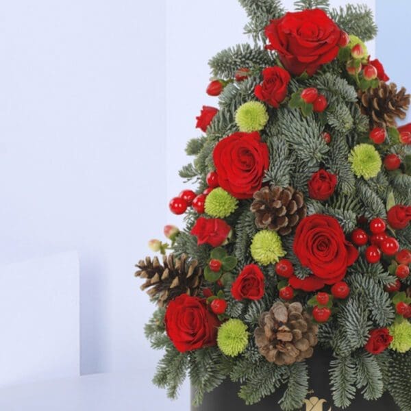 3 Merry Mini-Christmas tree A Christmas tree-shaped floral arrangement in a black pot. The arrangement features red roses, green foliage, pine cones, and berries.