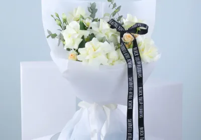 baby rose bouquet with white wrap