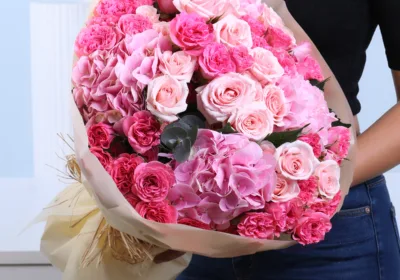 Blushing Pink Rose Bouquet featuring dark pink and light pink spray roses with hydrangea arranged in a soft and elegant hand-tied bouquet