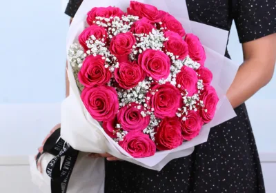 Deep Pink Floral Bouquet featuring 12 pink roses and gypsophila arranged in a rich and elegant floral design for gifting and celebrations