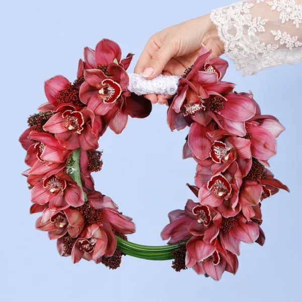 modern-cymbidium-bridal-bouquet Modern Cymbidium Bridal Bouquet featuring red cymbidium orchids, skimmia berries, and sculptural steel grass in a contemporary bridal arrangement