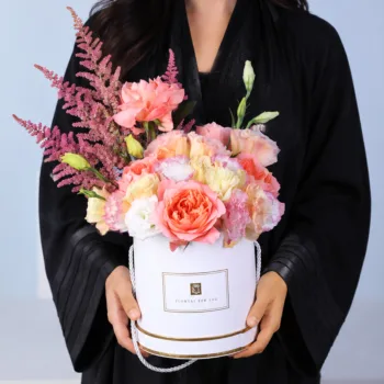 Pastel Eid Bloom Box featuring peach roses, peach lisianthus, pink lisianthus, and pink astilbe arranged in a premium Eid floral box with topper