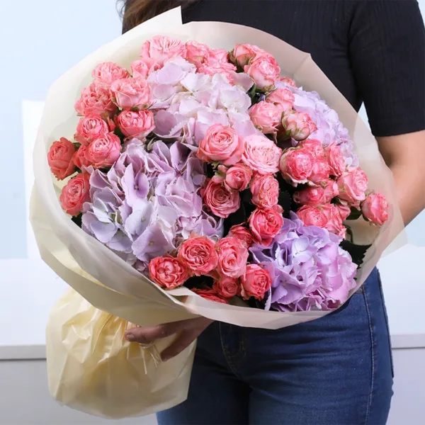 pastel-symphony-bouquet Pastel Symphony Bouquet featuring orange spray roses and purple hydrangea arranged in a vibrant and elegant floral design