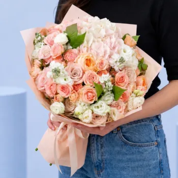 Peach Pink Harmony Bouquet featuring peach roses, light pink roses, hydrangea, lisianthus, and matthiola arranged in a soft pastel floral design