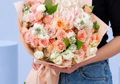Peach Pink Harmony Bouquet featuring peach roses, light pink roses, hydrangea, lisianthus, and matthiola arranged in a soft pastel floral design