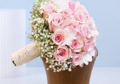 Pink Rose Bridal Bouquet featuring tightly arranged pink roses in a dome shape with baby’s breath (gypsophila) accents on the side