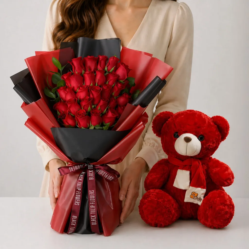 Red Roses Teddy Combo featuring 25 red roses with ruscus greenery paired with a 50cm red teddy bear for romantic gifting