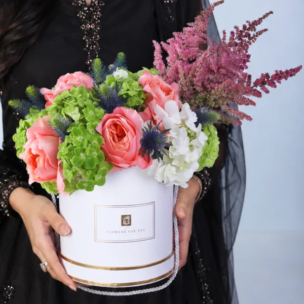 royal-eid-floral-gift Royal Eid Floral Gift featuring peach roses, red astilbe, blue eryngium, and green and white hydrangeas arranged in a white signature Eid box