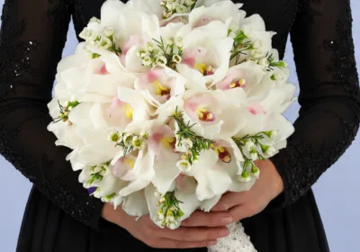 Timeless Orchid Wedding Bouquet featuring white cymbidium orchids and white wax flowers arranged in a soft romantic bridal design