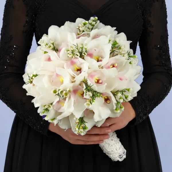 timeless-orchid-wedding-bouquet Timeless Orchid Wedding Bouquet featuring white cymbidium orchids and white wax flowers arranged in a soft romantic bridal design