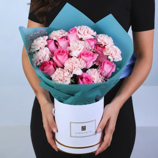 Dual Rose Carnation Box featuring 10 pink roses, 10 peach carnations, and 5 stems of fresh gypsophila arranged beautifully in an elegant hat box floral arrangement.