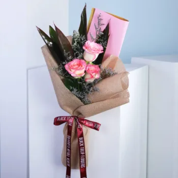 A trio of elegant roses in soft hues, arranged beautifully in a delicate bouquet, showcasing their natural beauty.