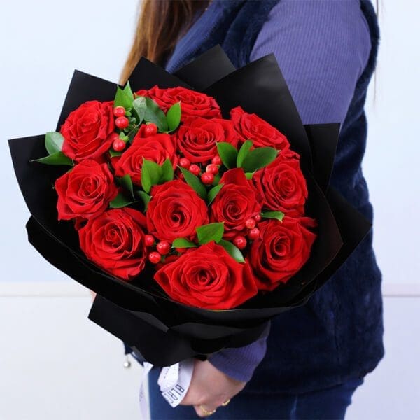 12-red-roses-hypericum-ruscus-black-wrap 12 red roses with hypericum berries and ruscus greens bouquet in elegant black wrapping