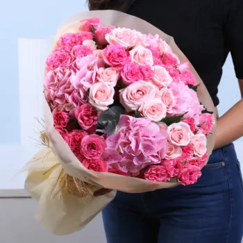 Blushing Pink Rose Bouquet featuring dark pink and light pink spray roses with hydrangea arranged in a soft and elegant hand-tied bouquet
