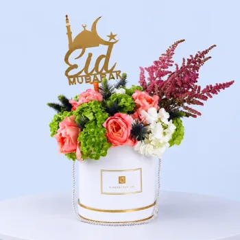 Eid Floral Harmony Box featuring hydrangeas, peach roses, eryngium blue, and astilbe arranged with an Eid wishes topper for festive gifting