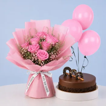 Blushing Rose Cake Combo featuring 7 pink roses, gypsophila, lepidium, 3 balloons, and a rich chocolate ganache cake for celebrations and gifting.